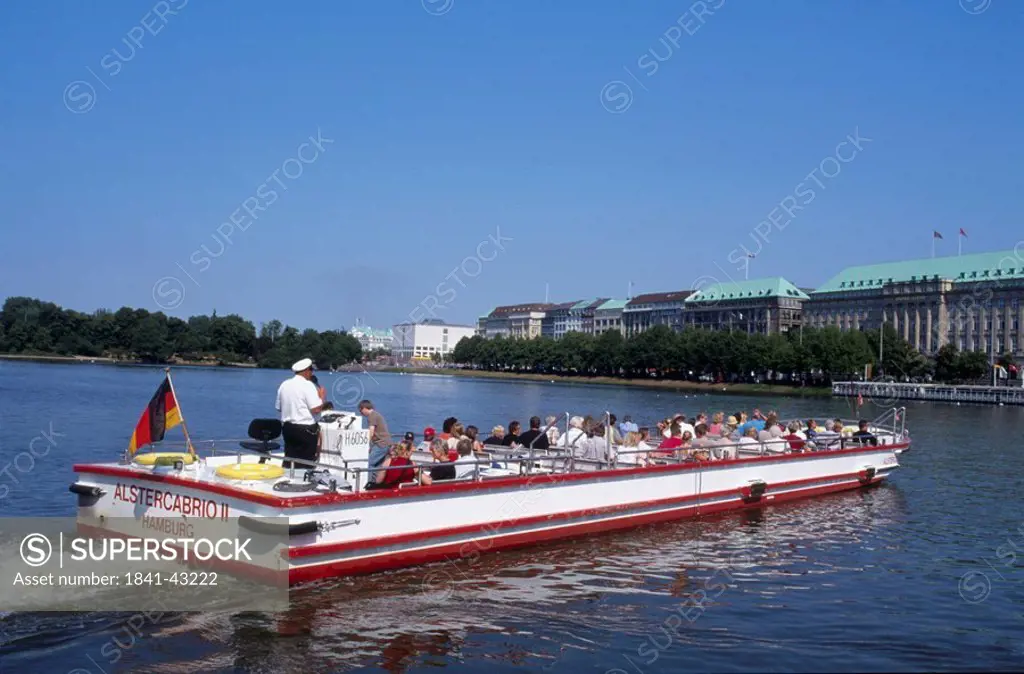 Tourists on tour boat in river, Alster River, Hamburg, Germany