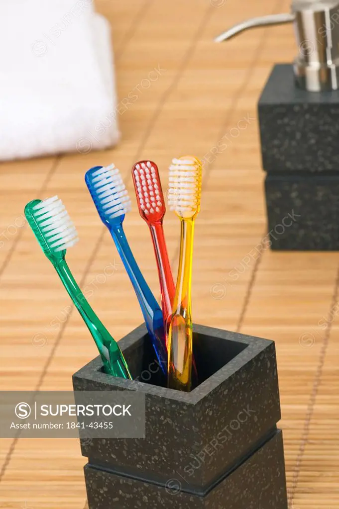 Close_up of toothbrushes in holder