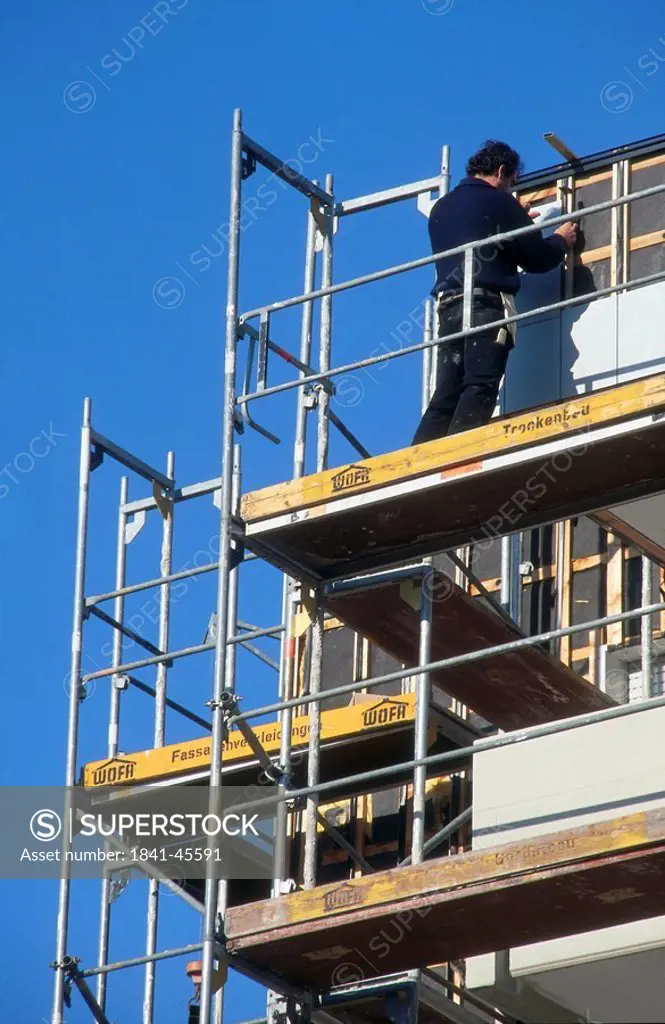 Craftsman on scaffolding, Stuttgart, Germany