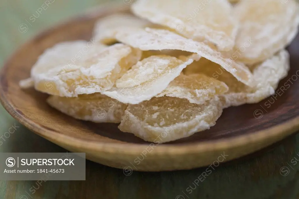 Close_up of crystallized ginger in wooden bowl