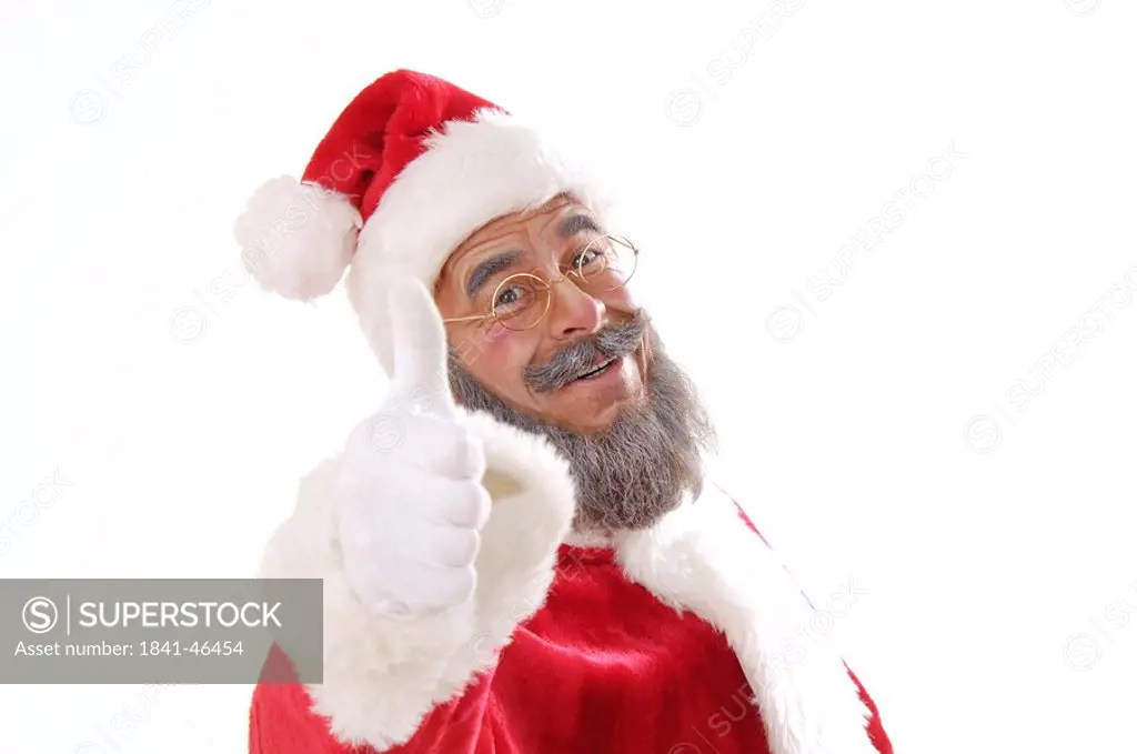 Portrait of senior man in santa costume making thumbs up sign