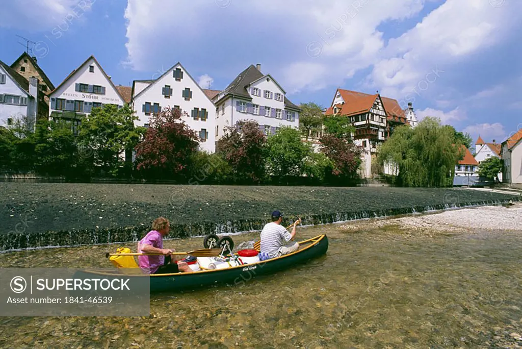 Two people boating in river, Danube River, Swabian Jura, Baden_Wurttemberg, Germany