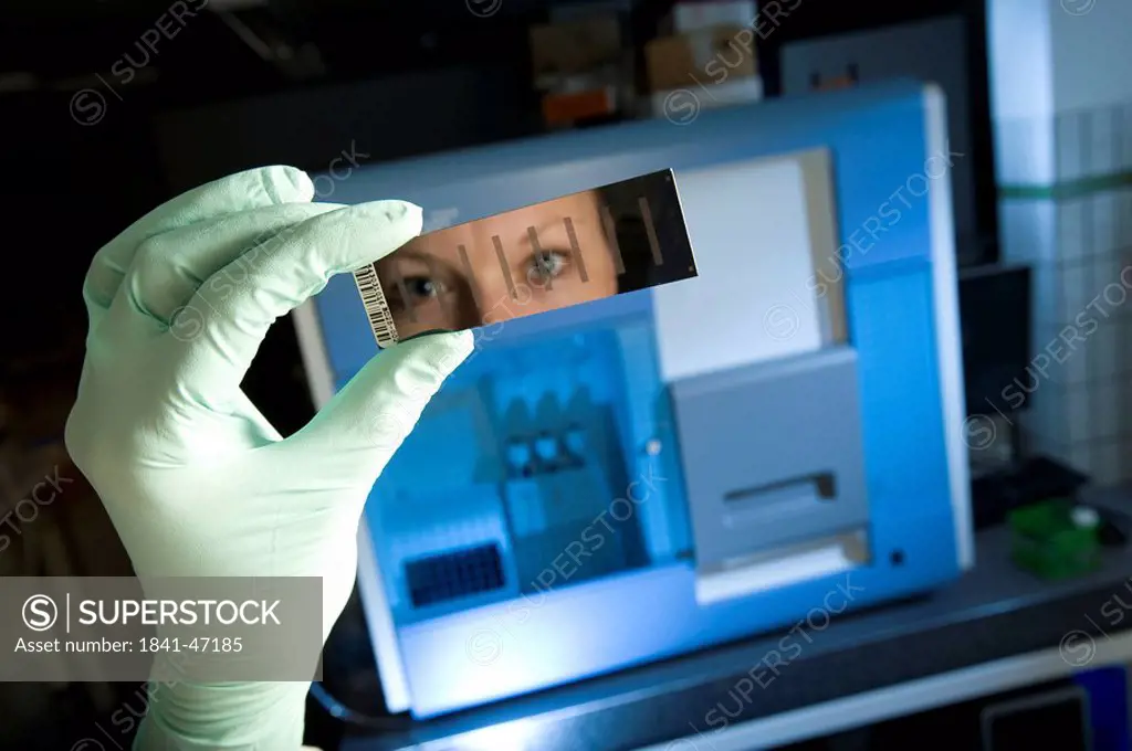 Female laboratory assistant with gene chip and reading device for sequencing and gene expression profiling, Max_Planck_Institute for molecular genetic...