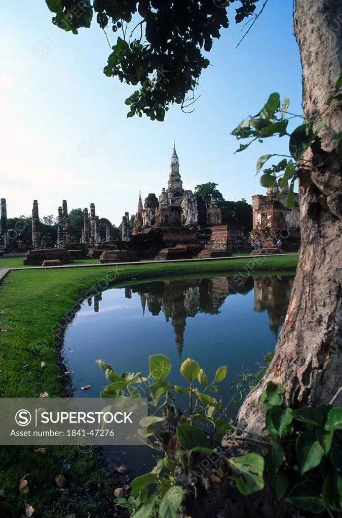 Ancient stupas reflected in pond water, Wat Mahathat, Sukhothai, Thailand