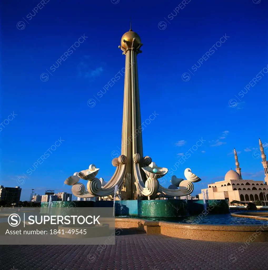 Monument against blue sky in city, King Faisal Mosque, Sharjah, UNITED ARAB EMIRATES
