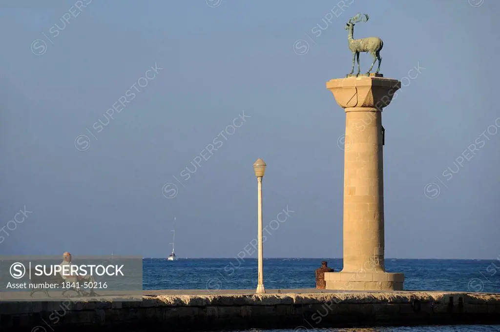 Column with stag statue at the port entrance of Rhodes, Greece