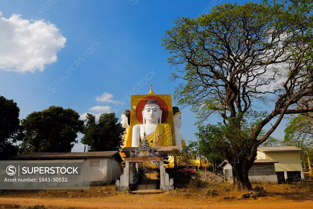 Tree in front of Buddhist temple, Kyaikpun Pagoda, Kyaik Pun Pagoda, Bago, Myanmar