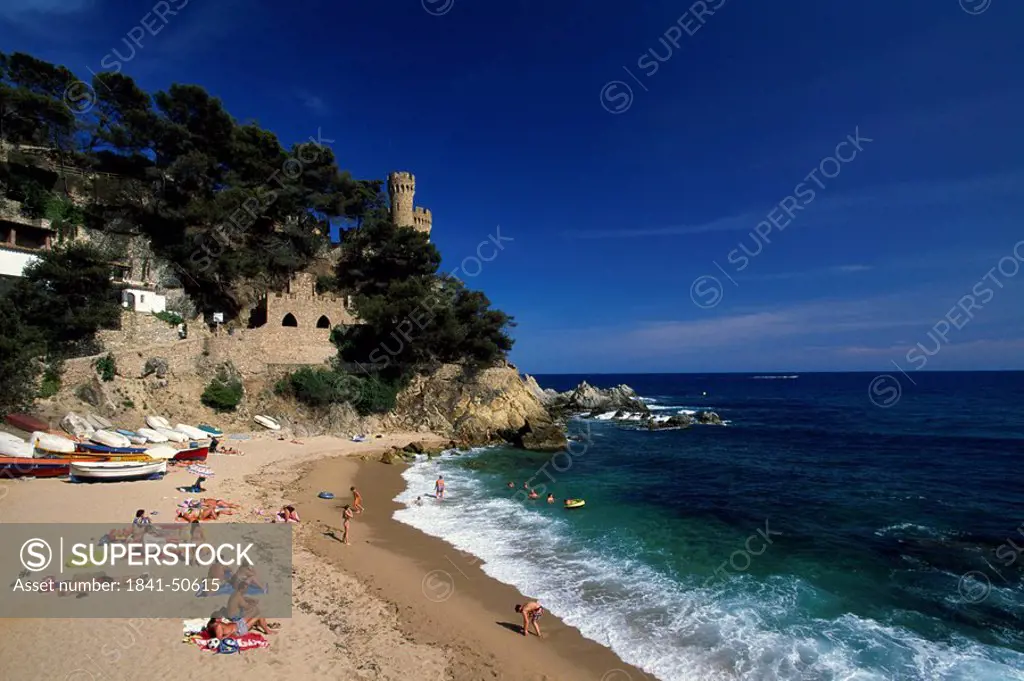 High angle view of tourists enjoying on beach, Lloret de Mar, Gerona, Catalonia, Spain