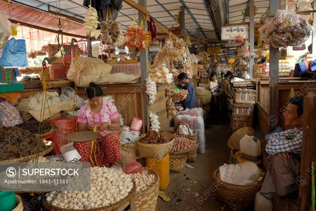 Vendors at market stall in town, Zegyo Market, Mandalay, Myanmar