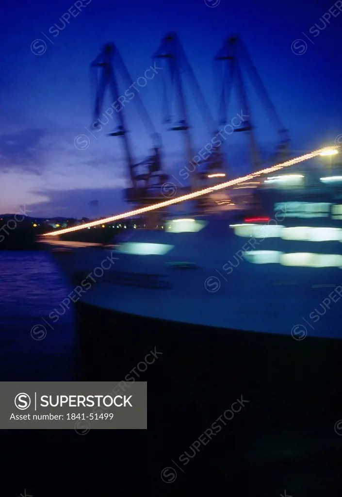 Cranes and ferry at harbor