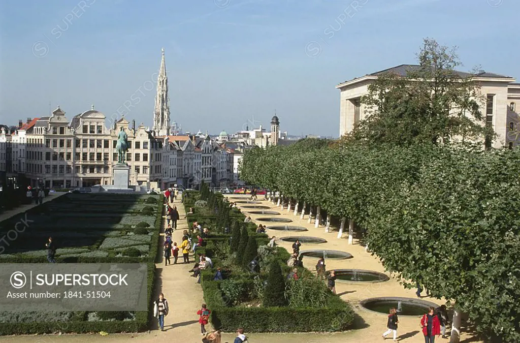 Tourists in garden with buildings in city, Brussels, Belgium