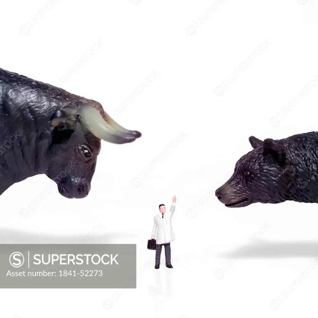 Figurines of businessman with bear and bull