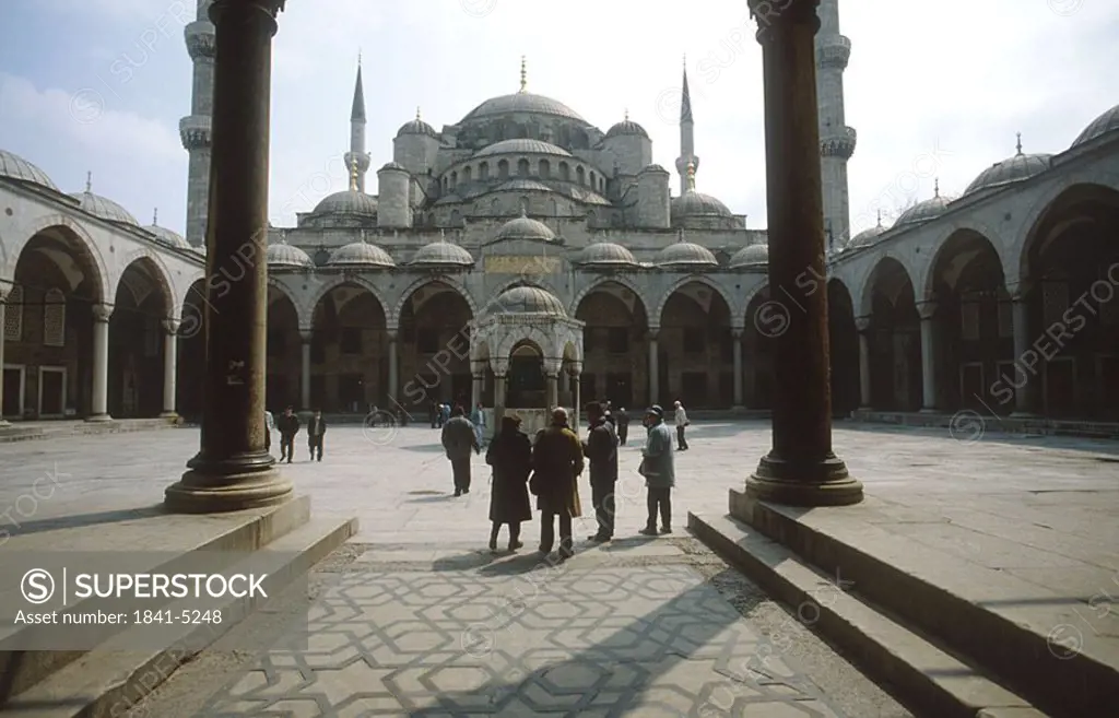 Tourists in courtyard of mosque, Blue Mosque, Istanbul, Turkey
