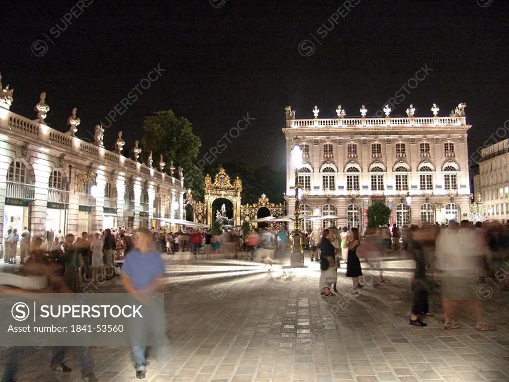 Group of people in front of museum lit up at night, Museum of Fine Arts, The Place Stanislas, Nancy, Lorraine, France