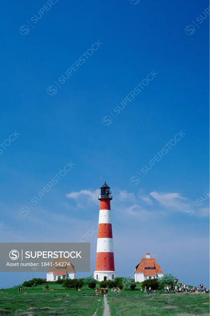 People on hill near lighthouse, Westerhever, Eiderstedt, Schleswig_Holstein, Germany