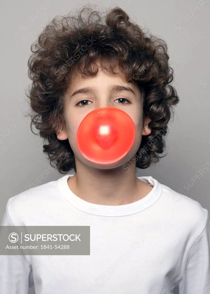 Portrait of boy blowing chewing gum