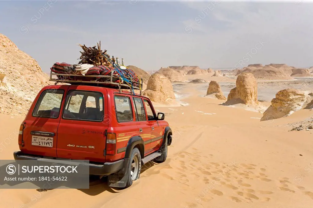 Car in arid landscape, Farafra Oasis, Libyan Desert, Egypt