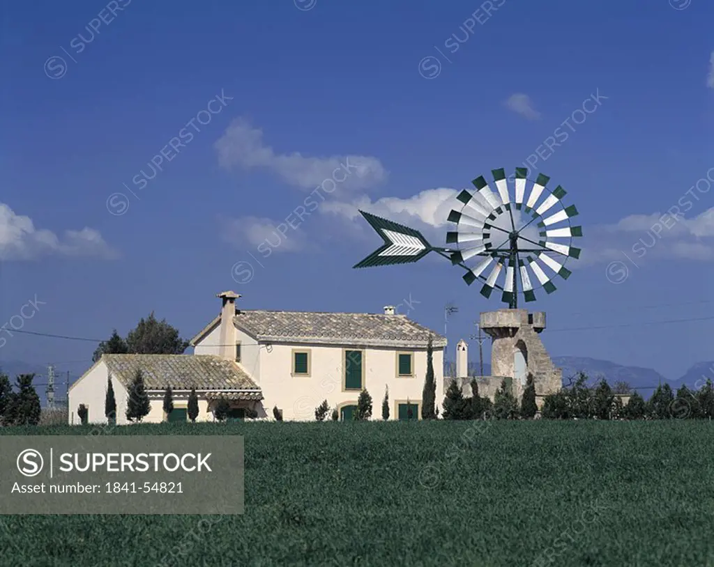 Traditional windmill on grassy landscape, Balearic Islands, Spain
