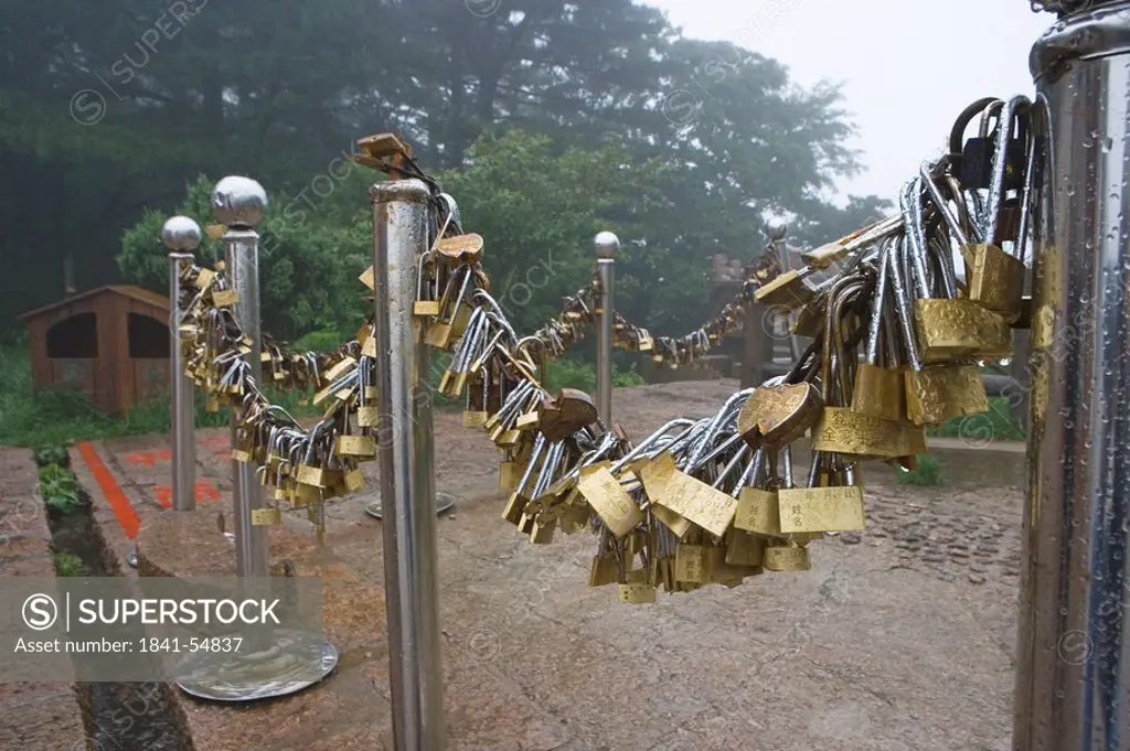 Chain of padlocks on metal poles, Montagnes de Huangshan, Anhui, China