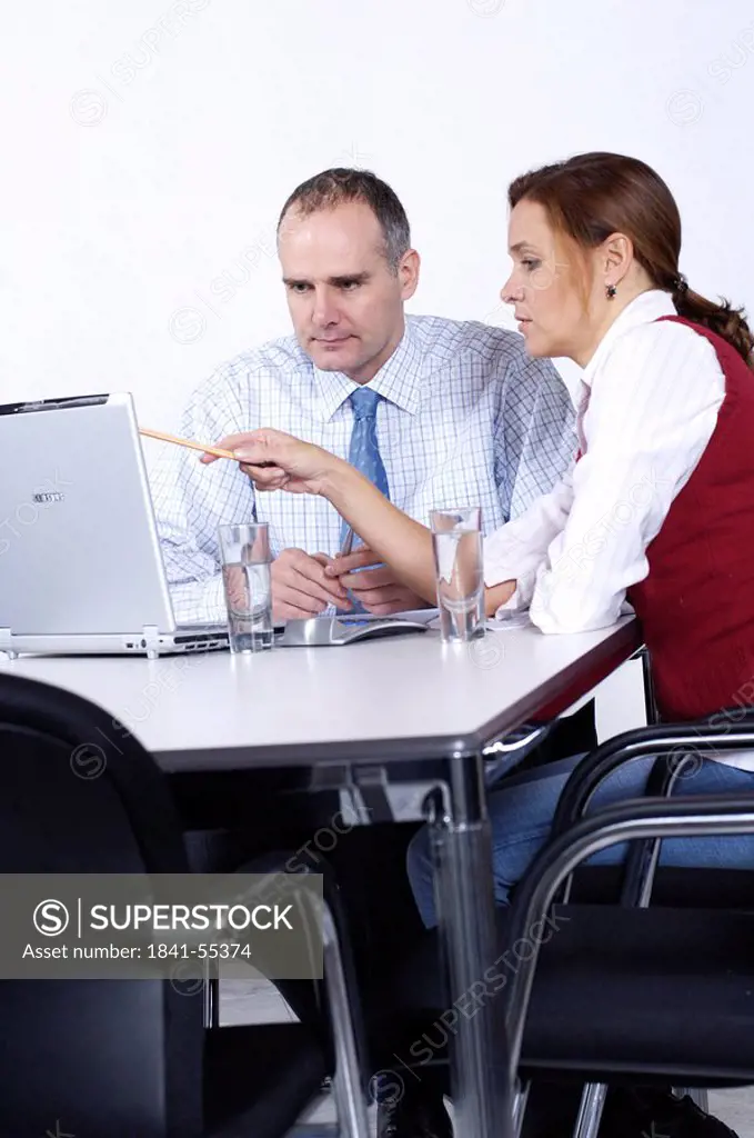 Two businesspeople looking at laptop