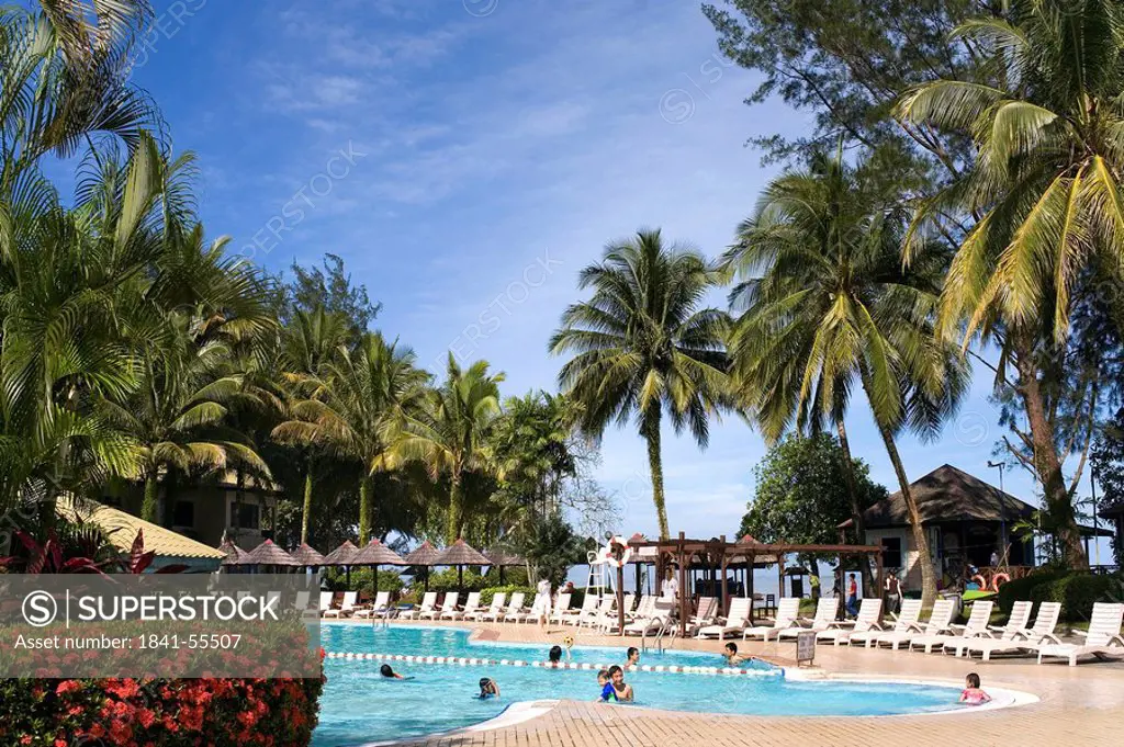 Tourists in swimming pool in resort, Damai Beach Resort, Kuching, Sarawak, Borneo, Indonesia