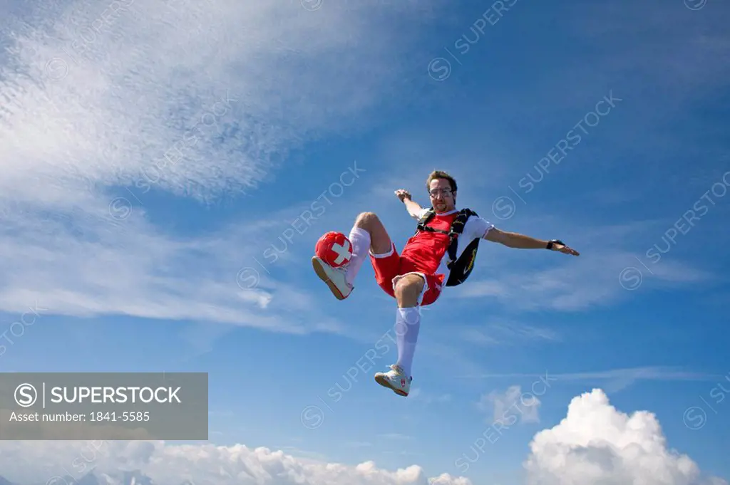 football player doing parachute jumping, full shot