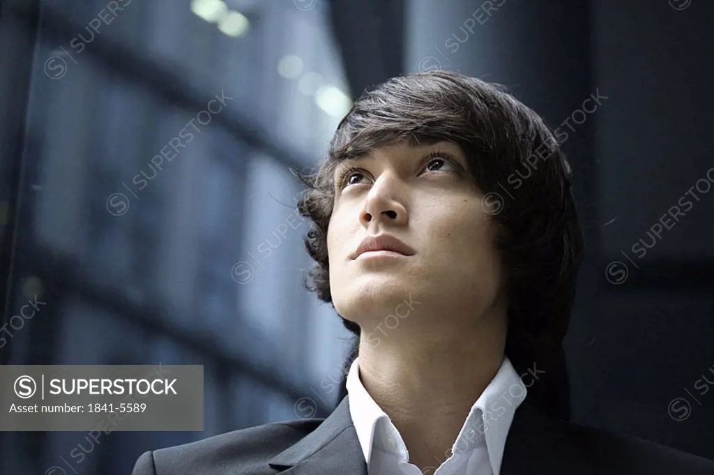 Portrait of young man looking upward
