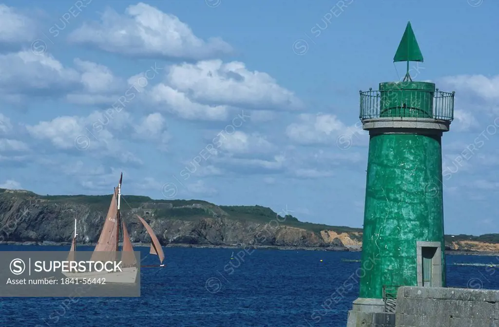 Lighthouse with sailboat in background, Camaret_Sur_Mer, Brittany, France