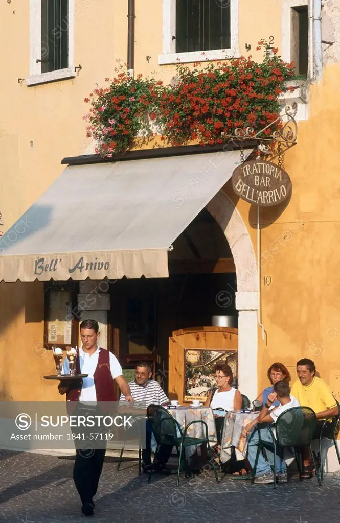 Tourists at outdoor cafe, Torre del Benaco, Lake Garda, Italy