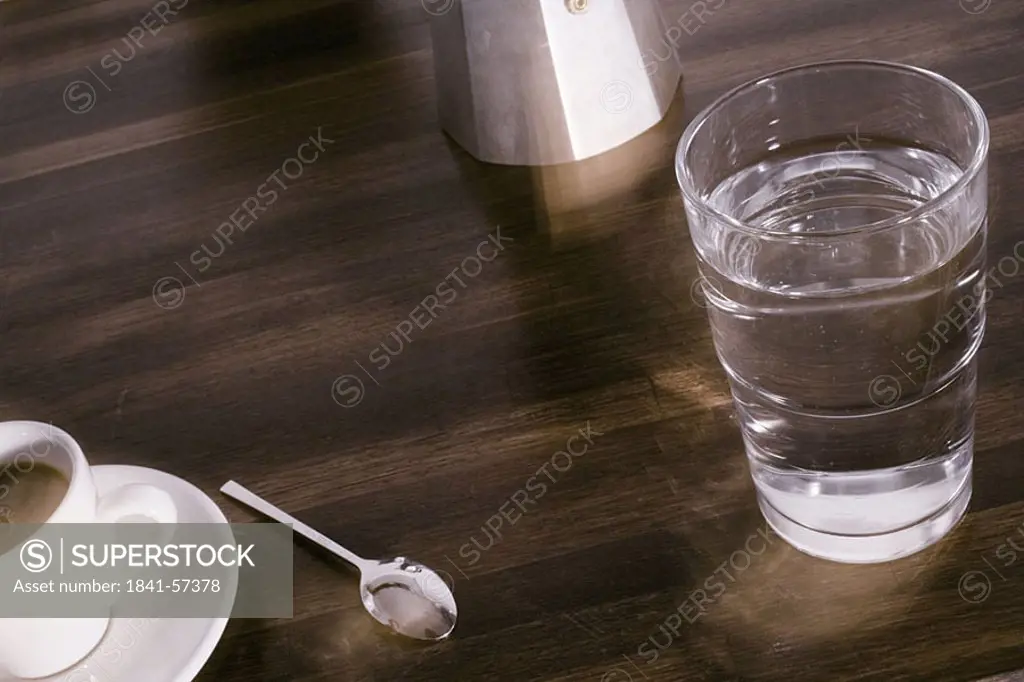 Close_up of glass of water and cup of coffee