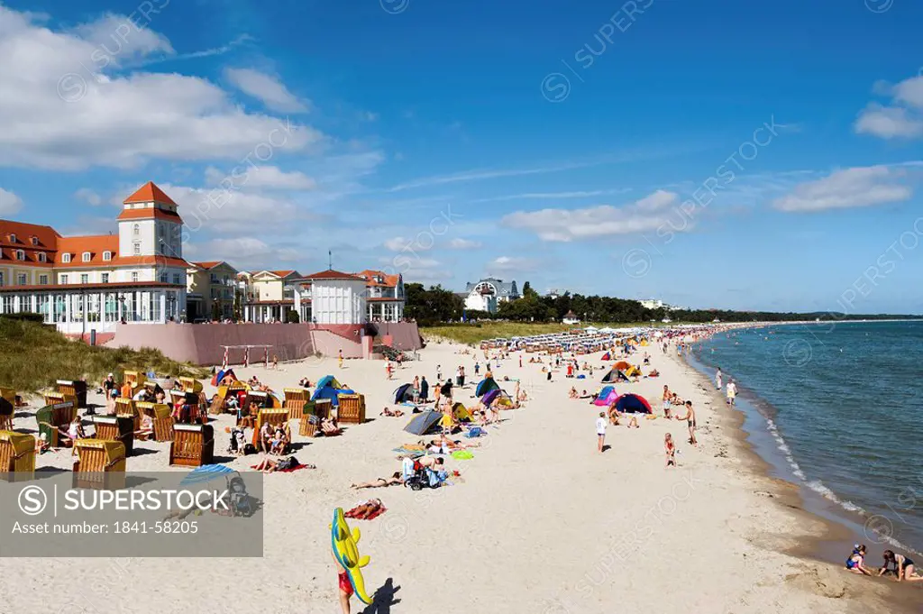 Tourists on the beach of Binz, spa hotel in the background, Ruegen, Germany, elevated view
