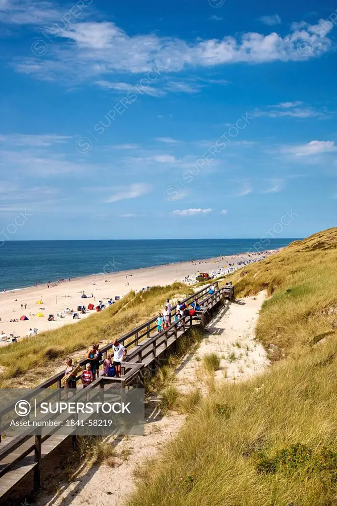 Tourists on a wooden footbridge on dunes, Wenningstedt_Braderup, Sylt, Germany, elevated view