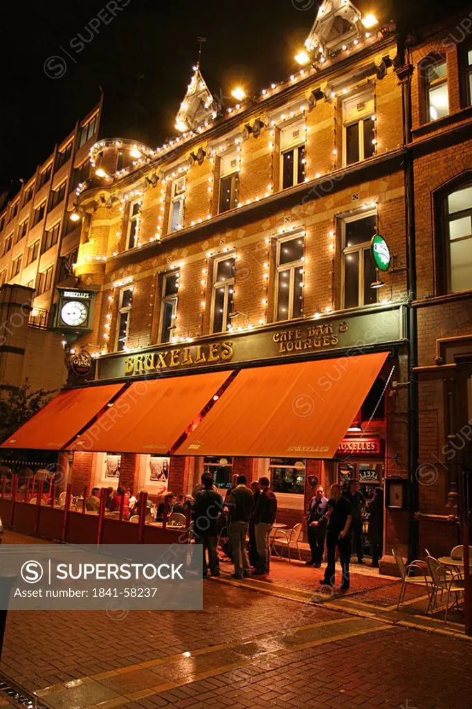 People at bar lit up at night, Dublin, Republic of Ireland