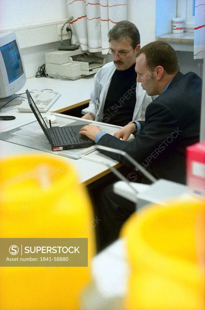 Two doctors using laptop