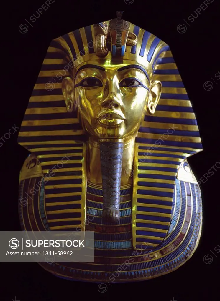 Death mask of Tutankhamun against black background, Egypt