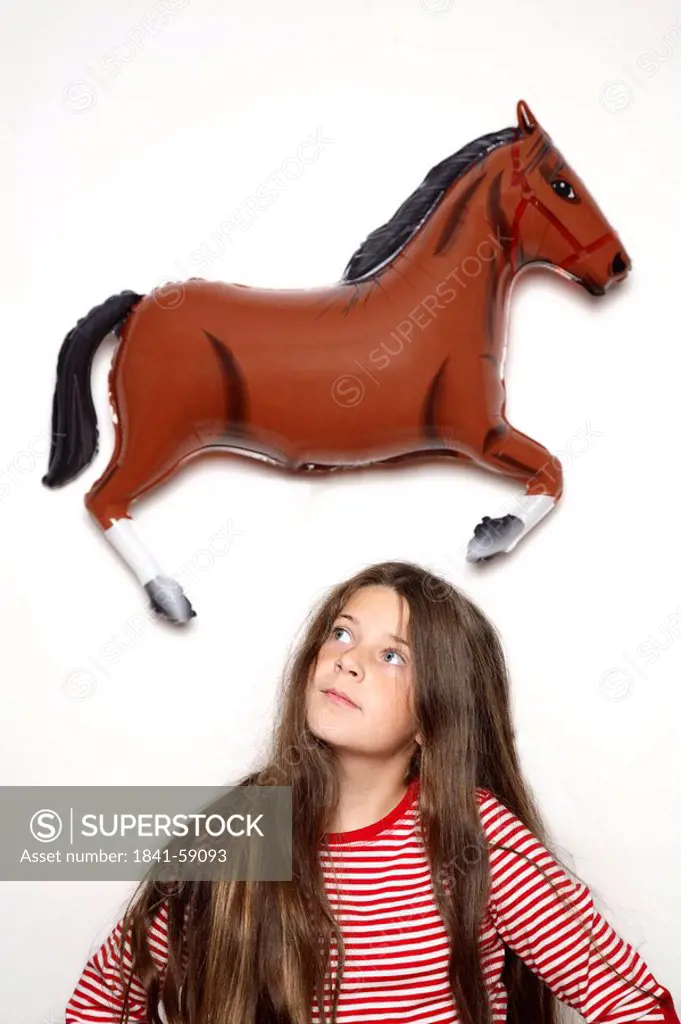 Close_up of girl looking at horse