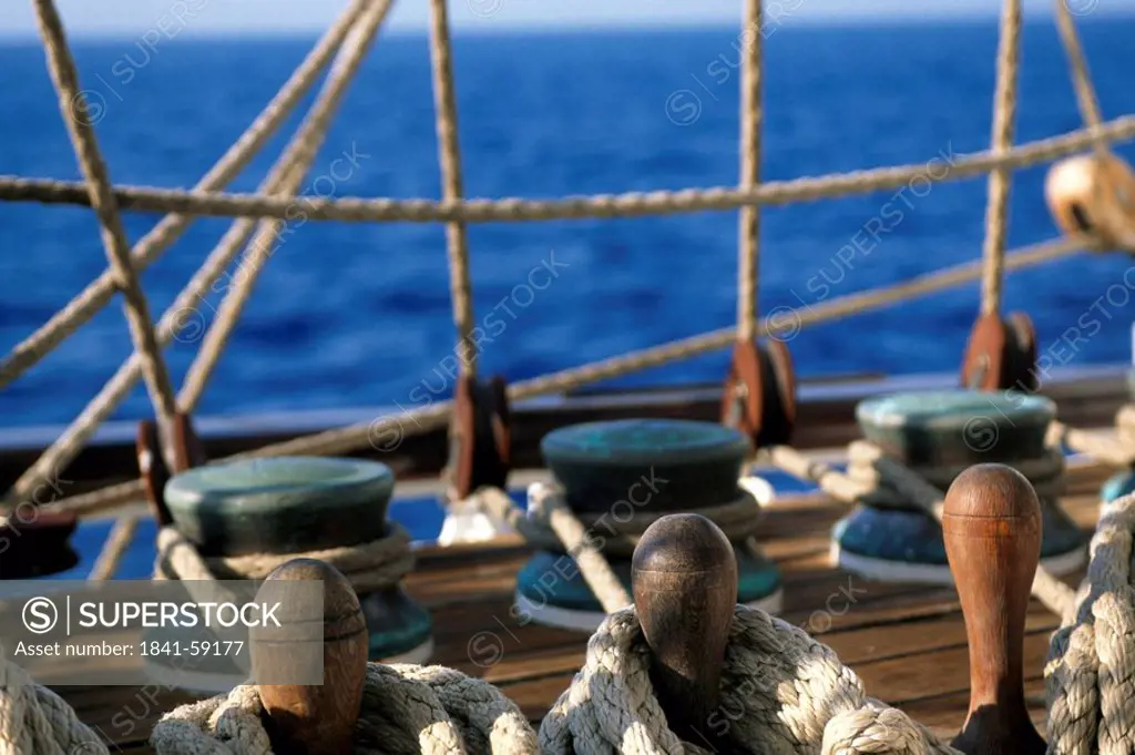 Row of rope pulleys on sailboat deck