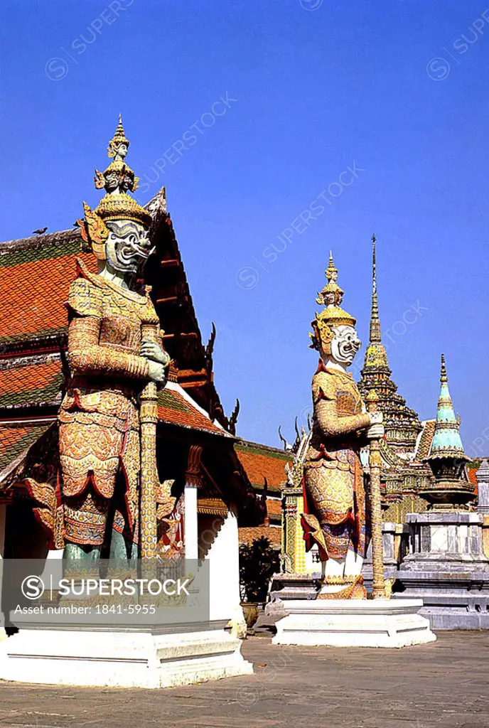 Statues at entrance of temple, Wat Phra Kaeo, Bangkok, Thailand