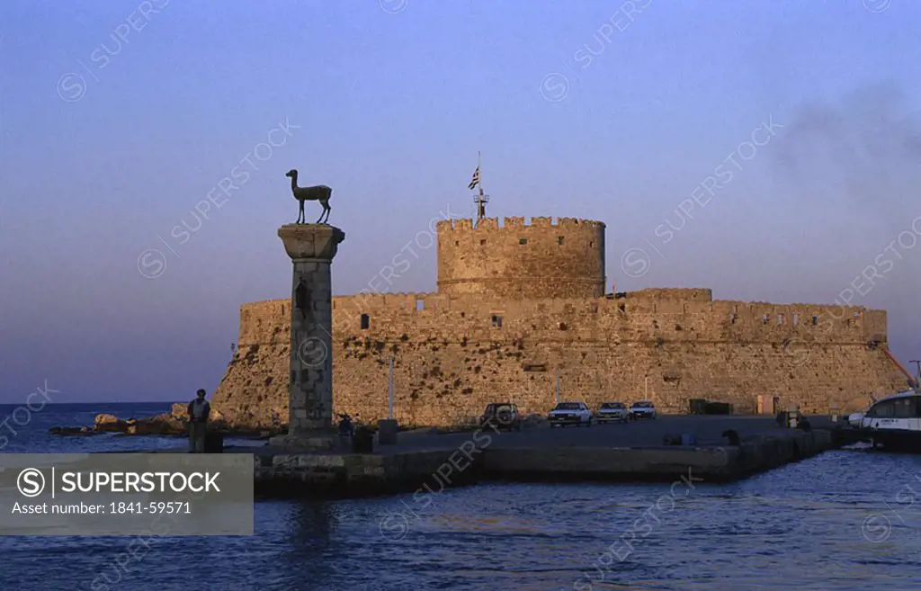 Silhouette of person standing near column in front of castle, Agios Nikolaos Castle, Rhodes, Dodecanese Islands, Greece