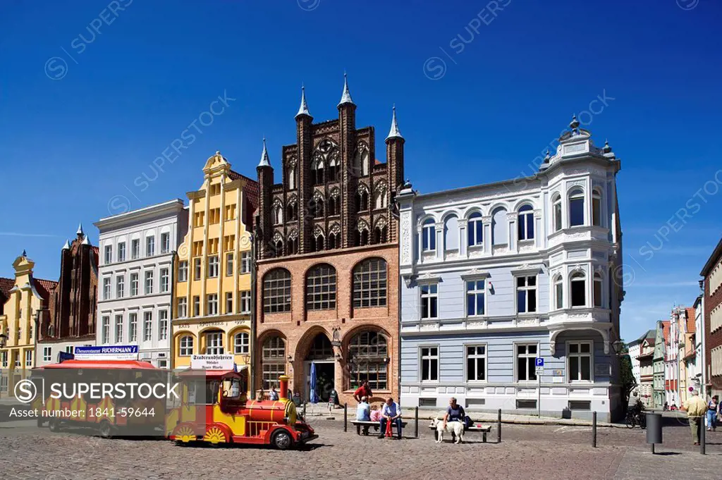 People sitting on benches at square, Stralsund, Mecklenburg_Western Pomerania, Germany