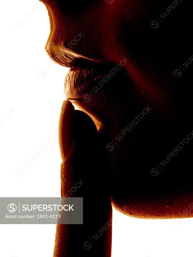 woman tipping with her finger her lip, close_up
