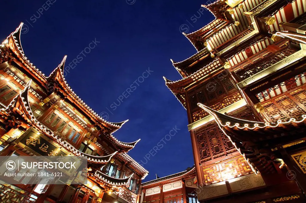 Low angle view of buildings lit up at night, Yuyuan Garden Bazaar, Shanghai, China