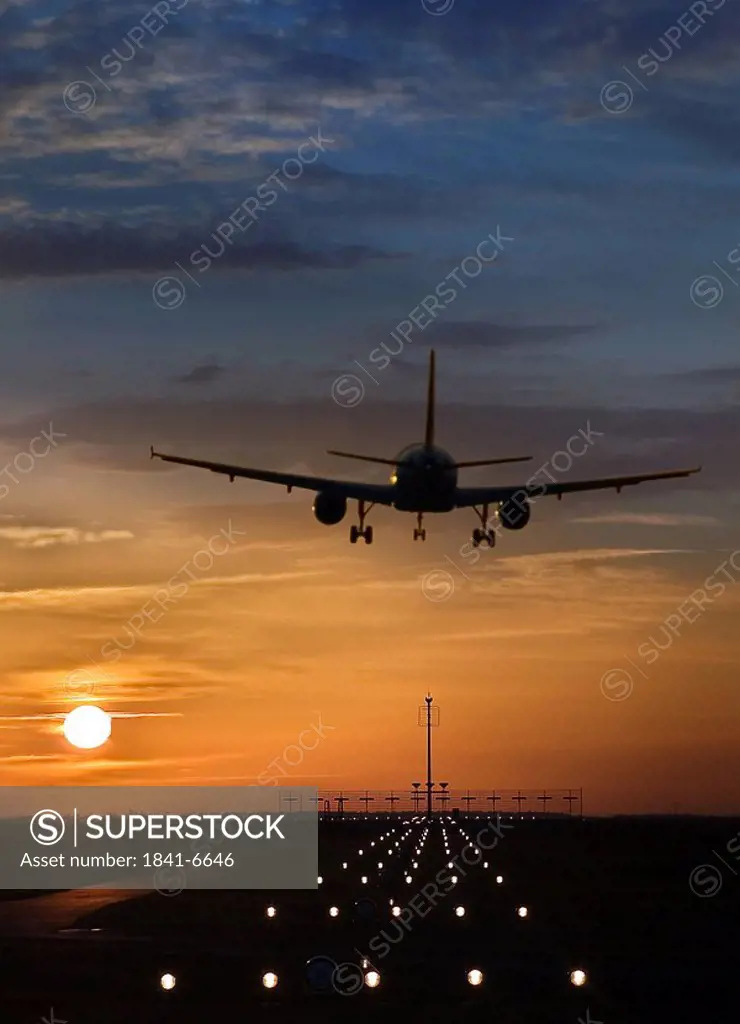 Airplane taking off from runway at dusk