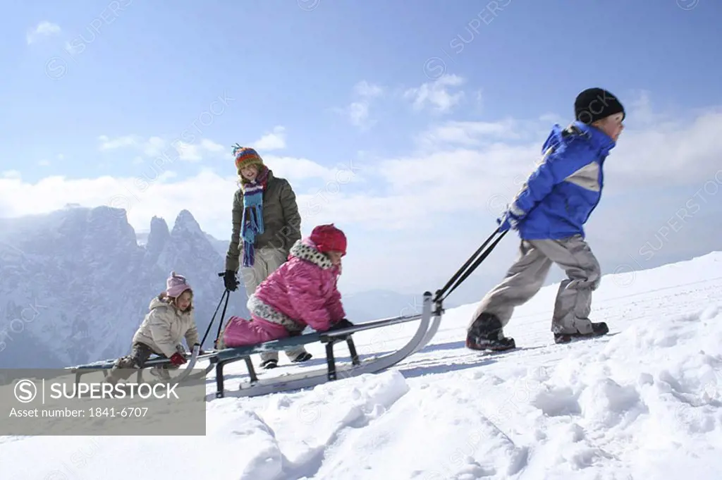 Woman with her three children on snow