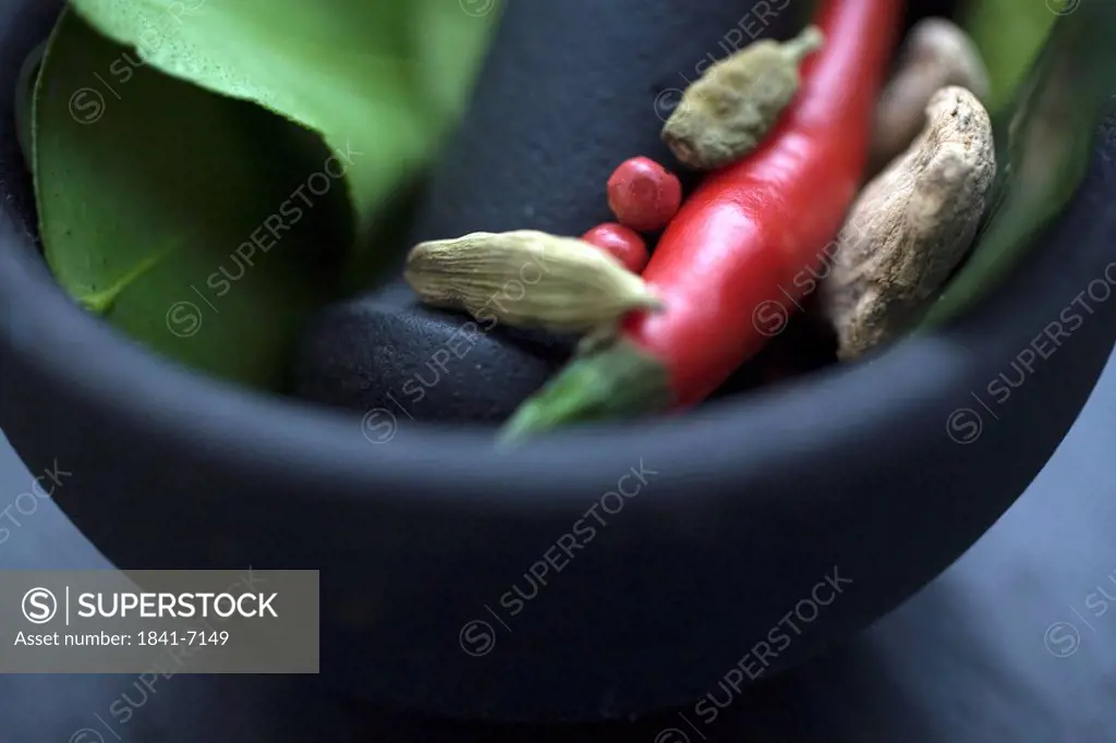 Close_up of spices in mortar with pestle