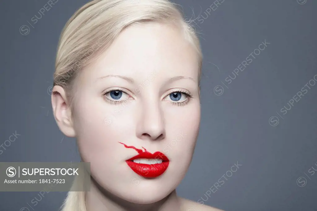 Young woman with blurred red lipstick, portrait