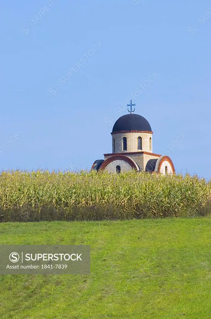 Field with church in background, Sandzak, Serbia