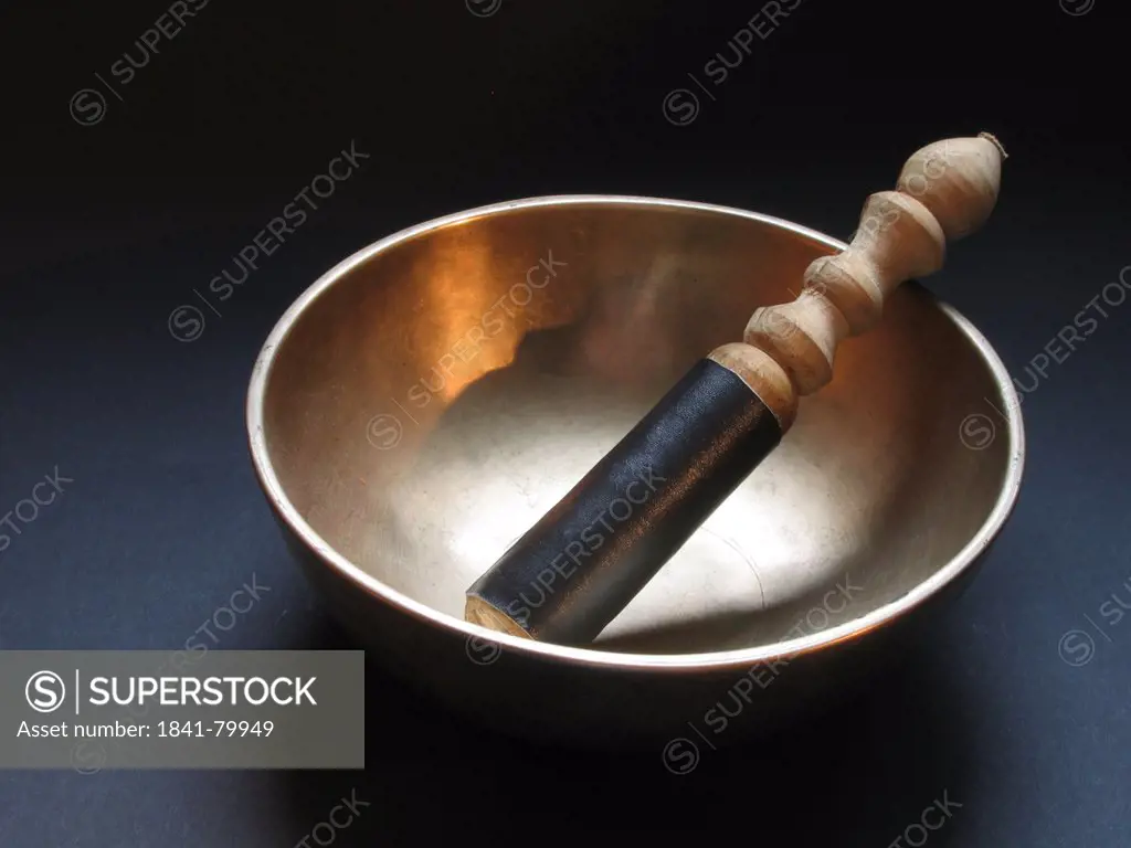 Close_up of metal bowl with pestle