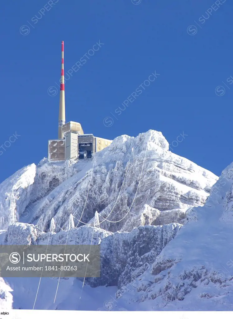 Communications tower on snow_capped mountain
