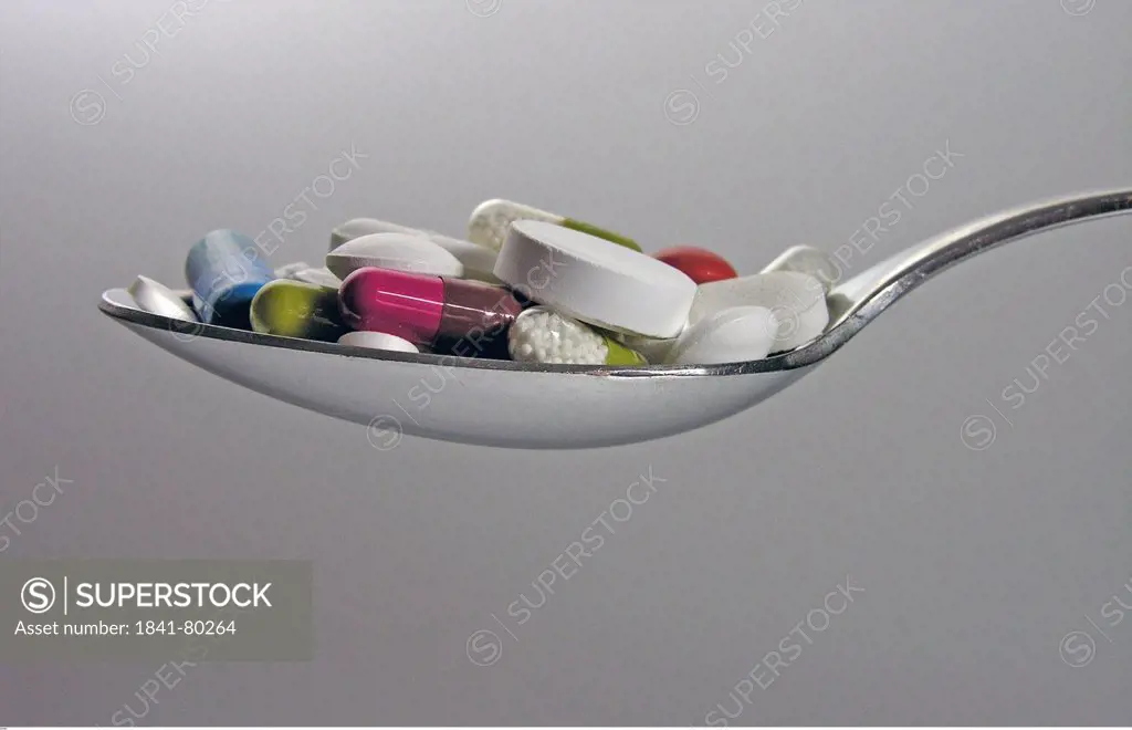 Medical pills in spoon